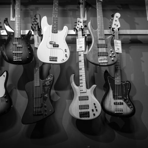8 Electric Guitars Hanged on Brown Steel Bar