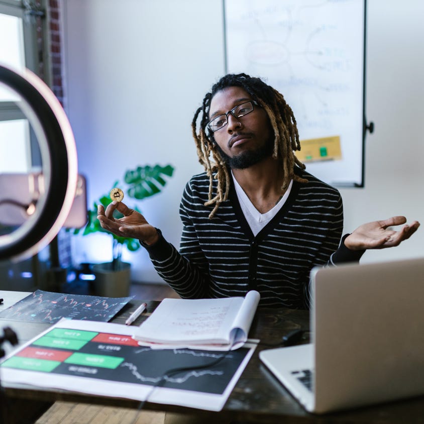 Male Vlogger holding a Gold Coin 